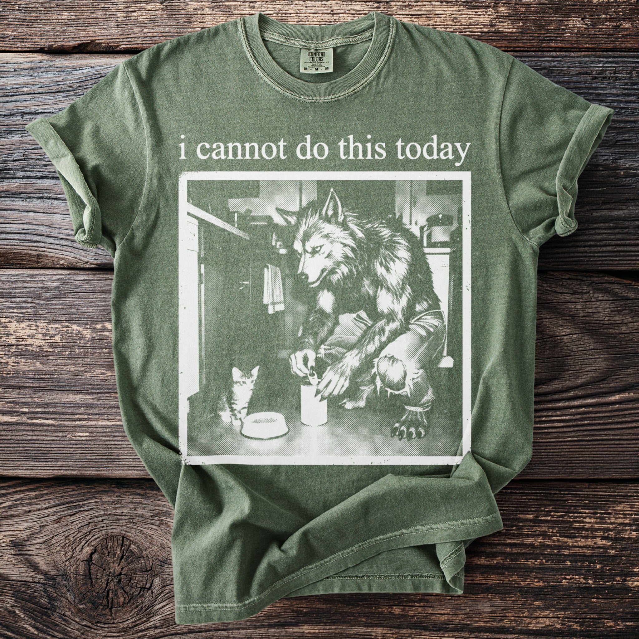 Green t-shirt with text "i cannot do this today" and werewolf with kitten graphic.