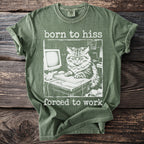 Green t-shirt with a print of a cat at a computer and the text "born to hiss forced to work".