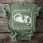 Sage green t-shirt with a distressed print of a hamster and sun surrounded by text.