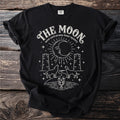 Black t-shirt with "The Moon tarot card arcana lunar mystery" and celestial design.