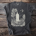 Dark t-shirt with white graveyard scene featuring a tomb, trees, bats, and a moon.