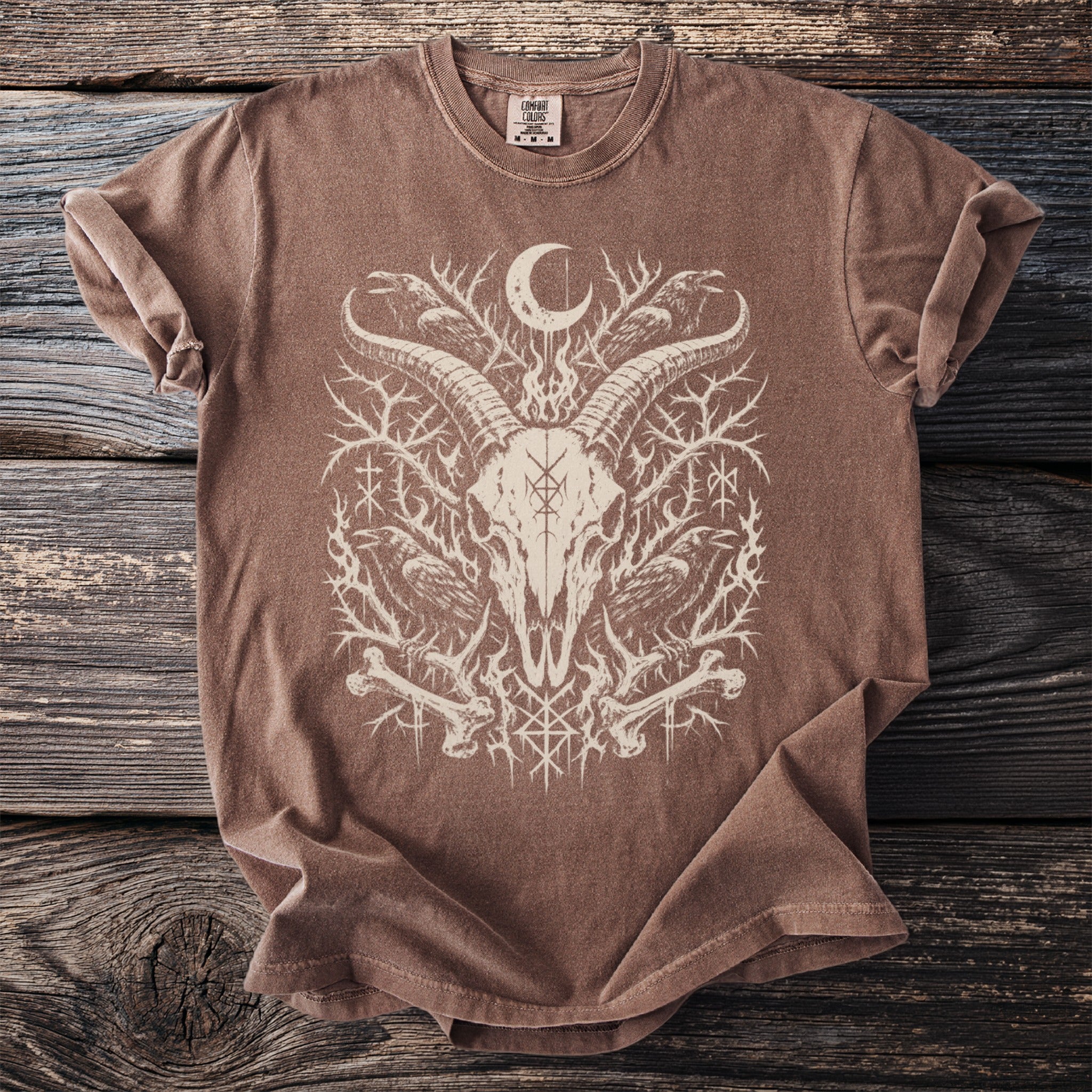 Brown t-shirt with occult graphic of goat skull, ravens, moon, and runes.