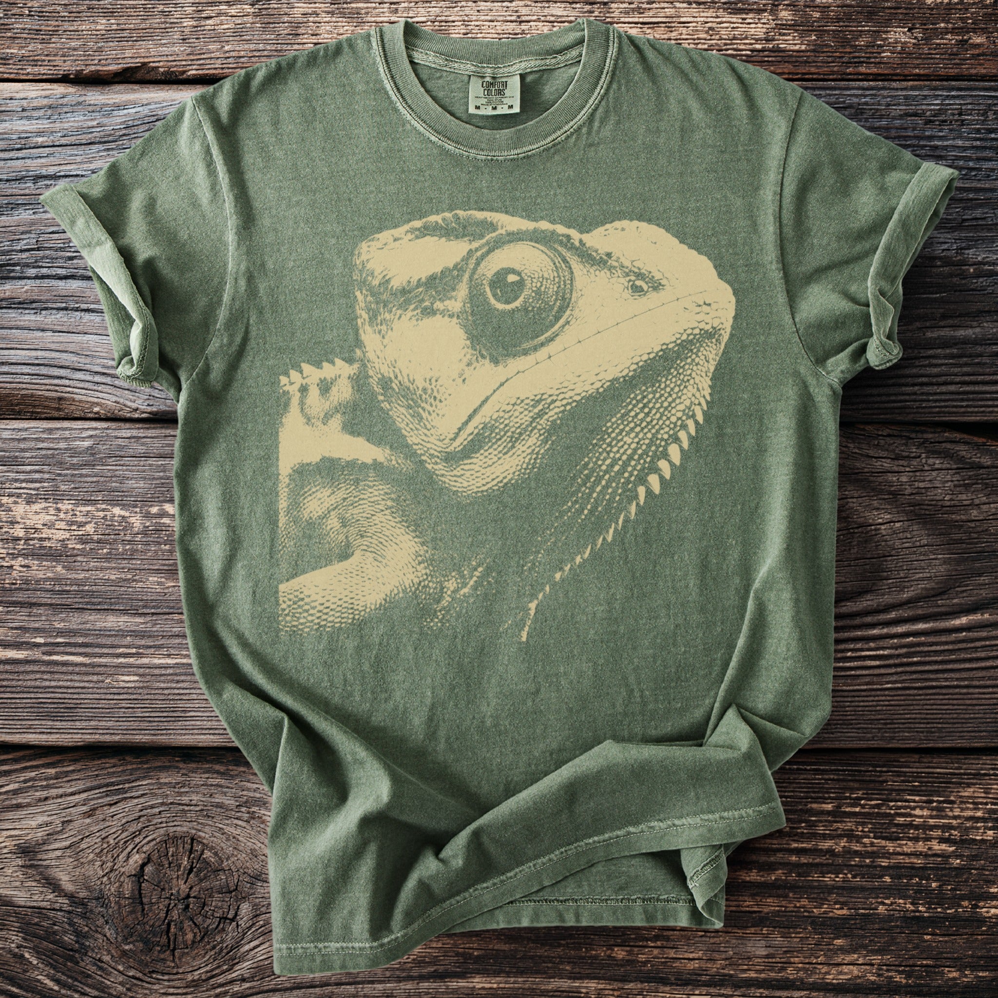Green t-shirt with a beige lizard graphic and Comfort Colors tag.