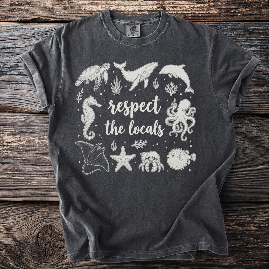 Dark grey t-shirt with white ocean animals and text "respect the locals."