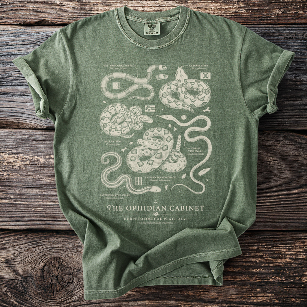 Green t-shirt with detailed snake illustrations and text "The Ophidian Cabinet".