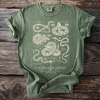 Green t-shirt with detailed snake illustrations and text "The Ophidian Cabinet".