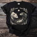 Black t-shirt with a graphic of two bears and a fish in water under a moonlit sky.