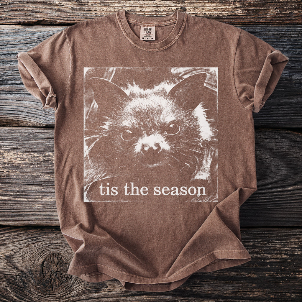 Brown t-shirt with a white bat face graphic and text "tis the season".