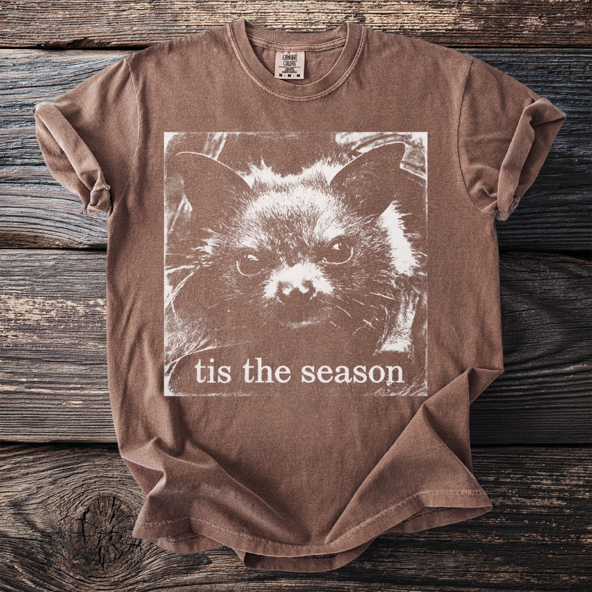 Brown t-shirt with a white bat face graphic and text "tis the season".