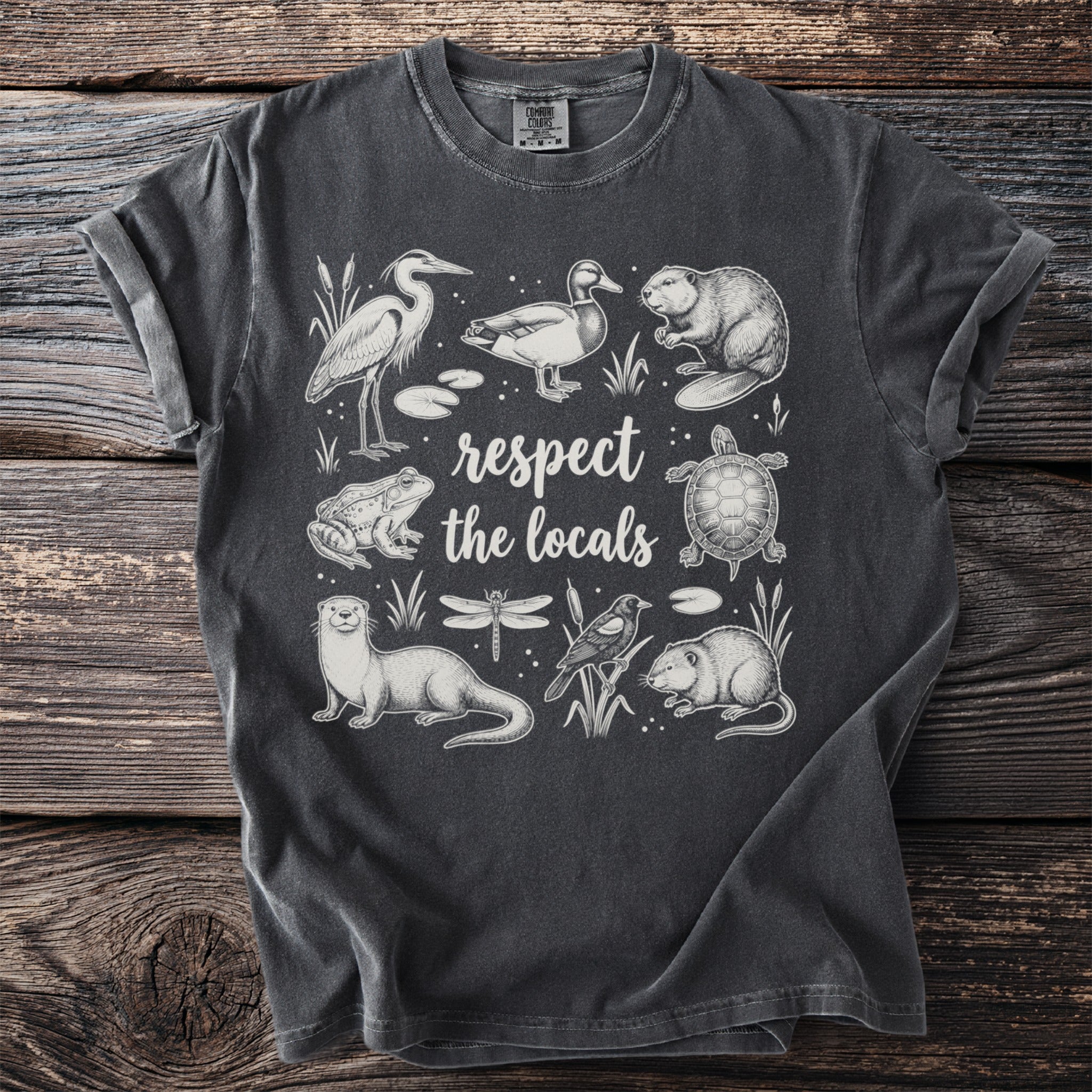 Dark grey t-shirt with "respect the locals" and line drawings of local wildlife.