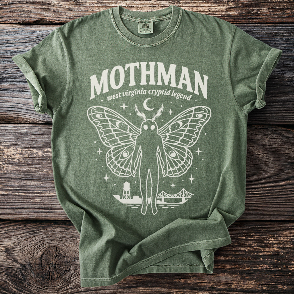 Green t-shirt with "Mothman west Virginia cryptid legend" and Mothman graphic.