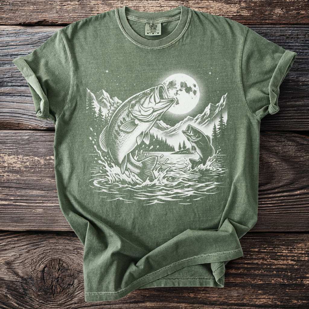 Green t-shirt with a graphic of bass jumping from a lake under a full moon.