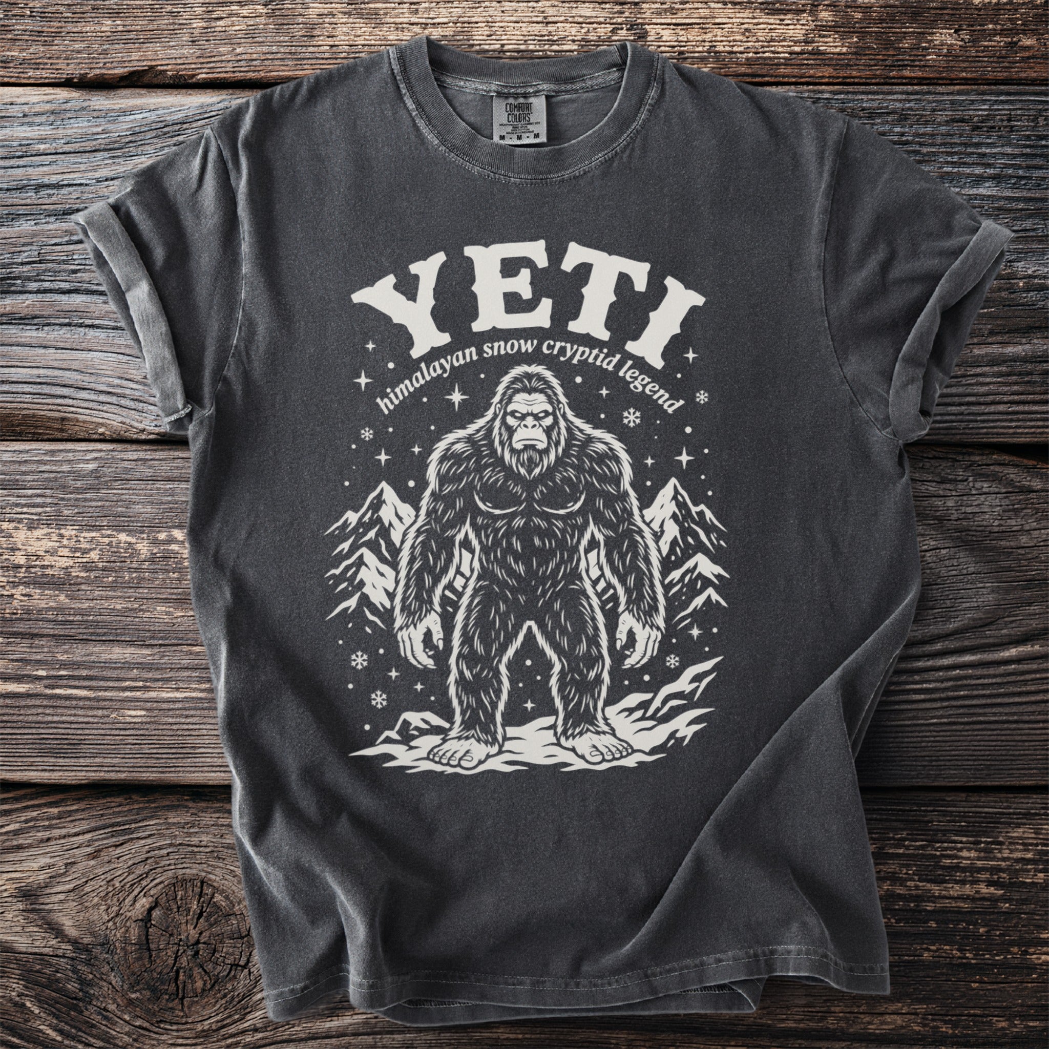Dark grey t-shirt with Yeti illustration and "Himalayan snow cryptid legend" text.