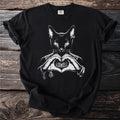 Black t-shirt with white graphic of a cat making a heart shape with hands.
