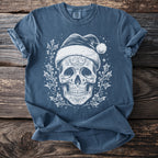 Blue t-shirt with a white graphic of a sugar skull wearing a Santa hat and surrounded by holly.