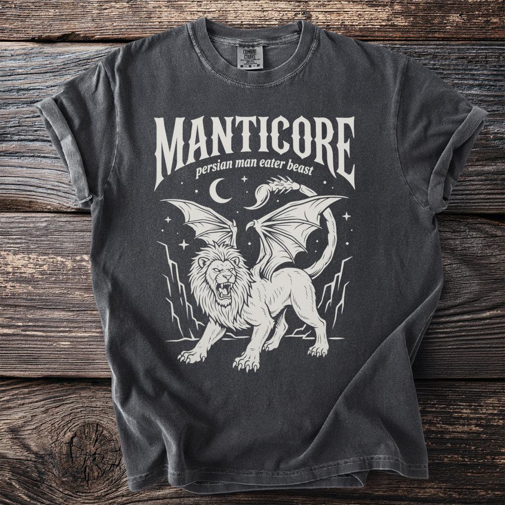 White Manticore creature design with text on a charcoal t-shirt.