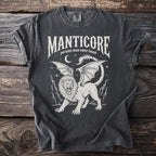 White Manticore creature design with text on a charcoal t-shirt.