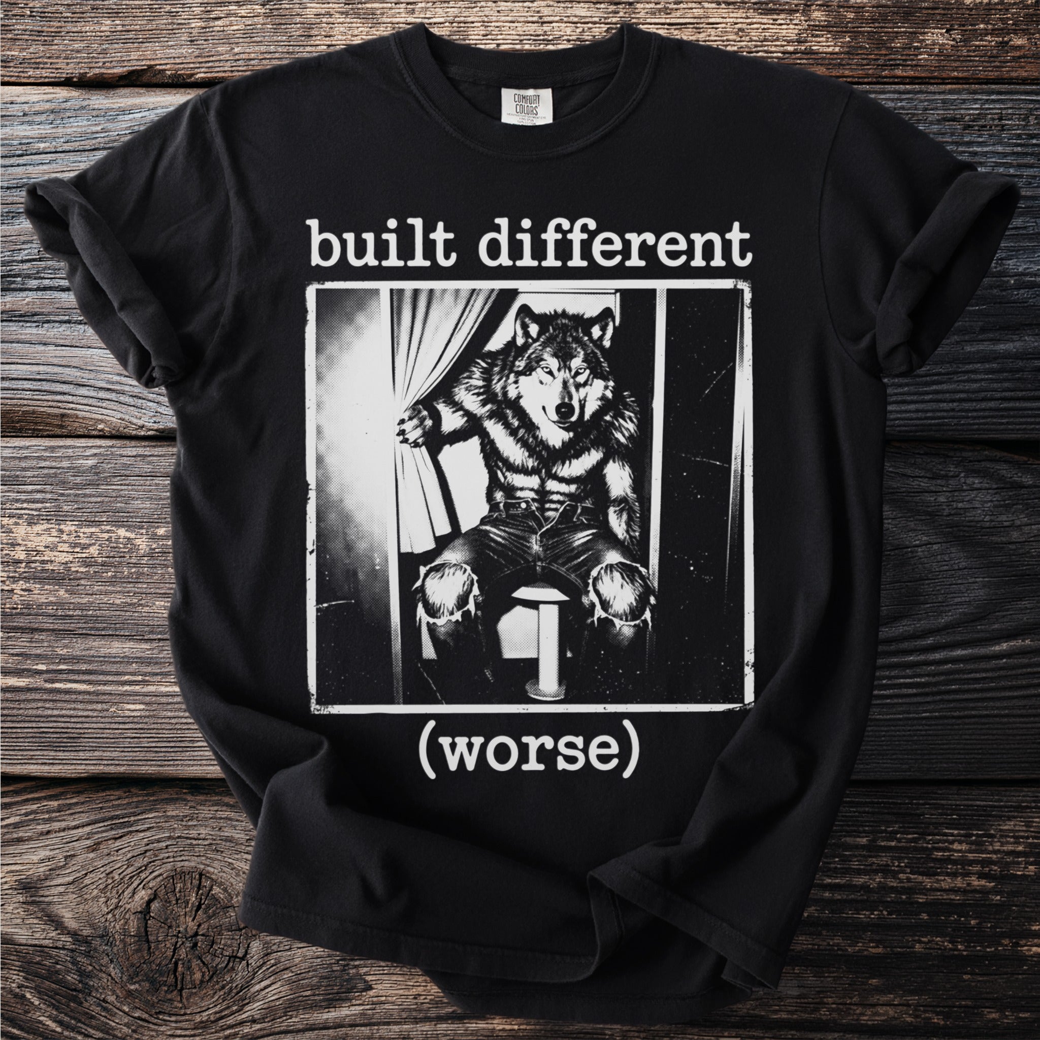 Black t-shirt with "built different (worse)" text and a wolf graphic.