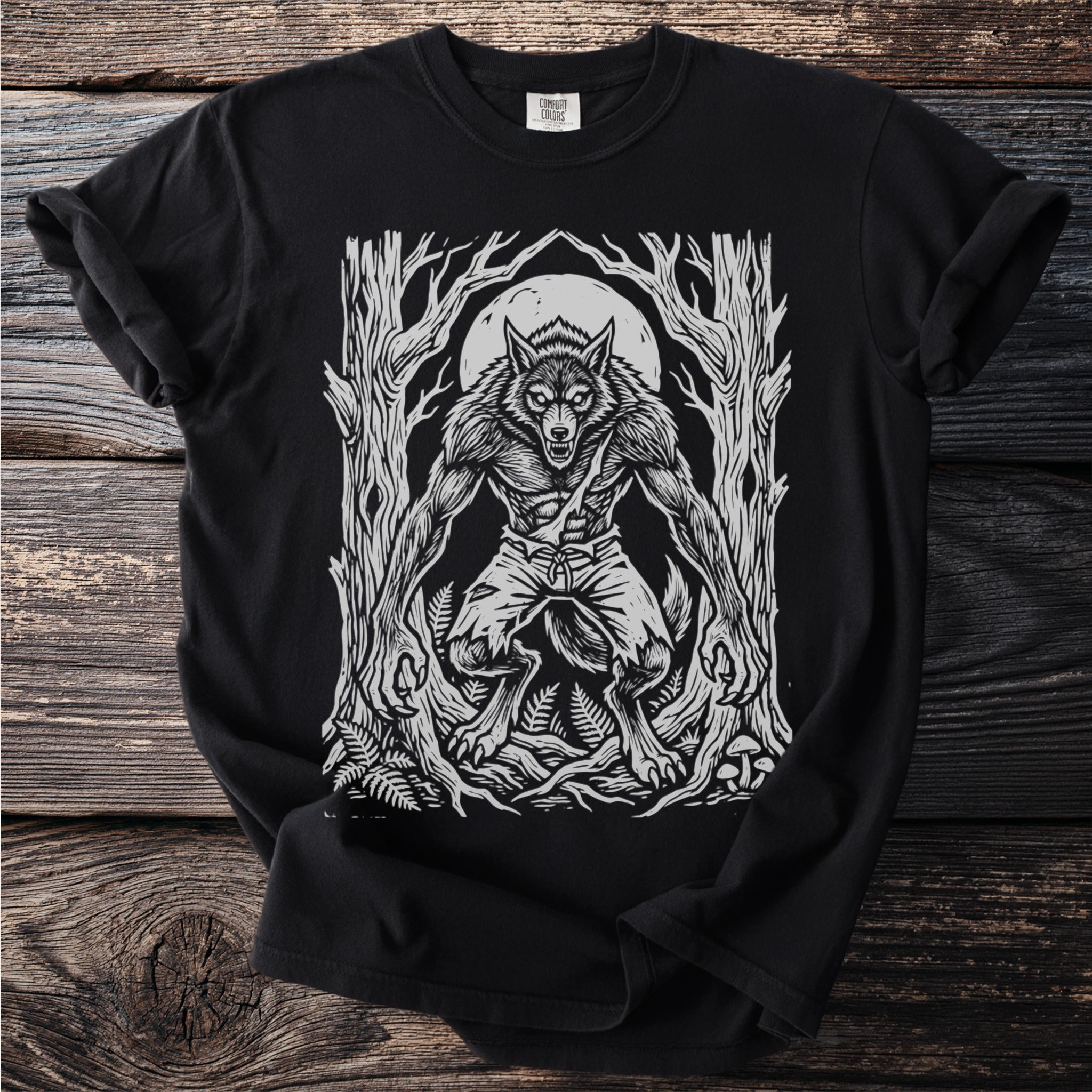 Black t-shirt with a white graphic of a werewolf in a forest under a full moon.