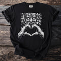 Black t-shirt with green man face and hands forming heart shape.