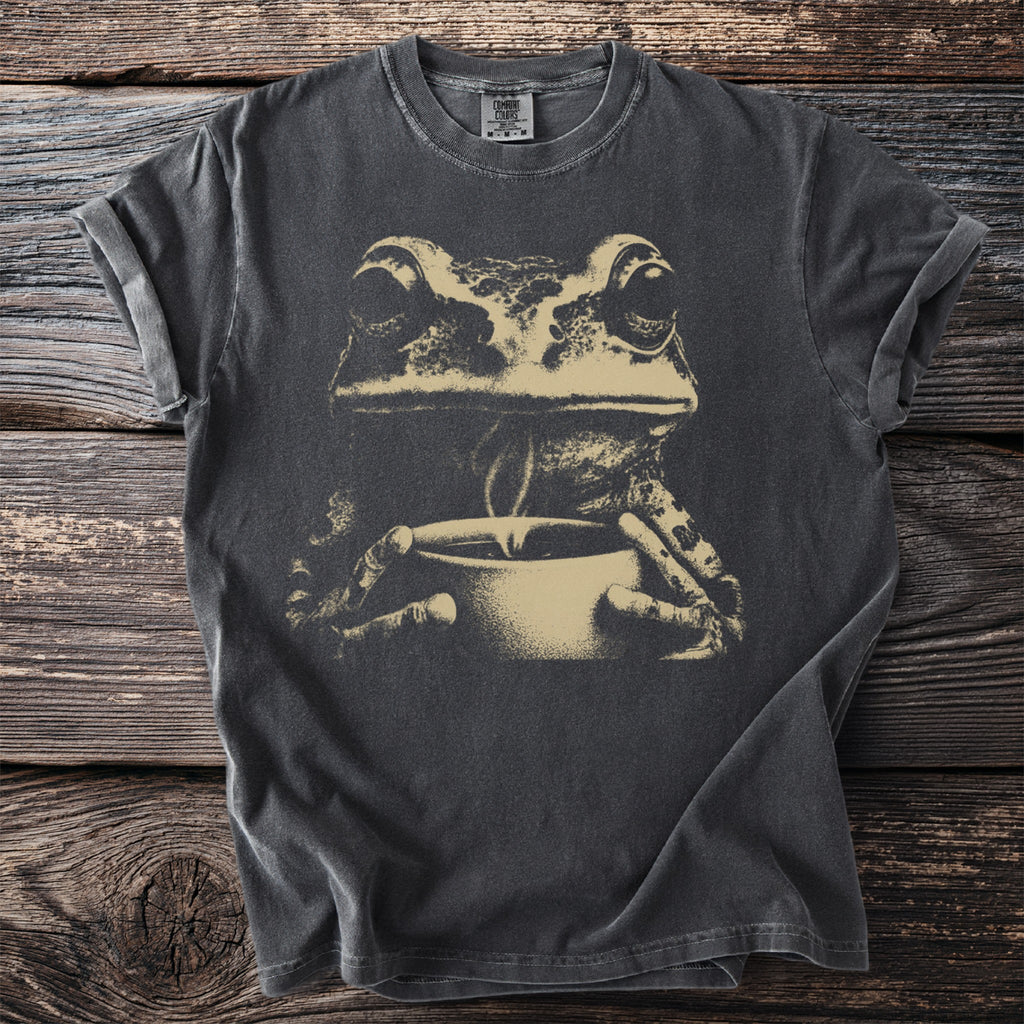 Dark gray t-shirt with a beige graphic of a frog holding a mug.