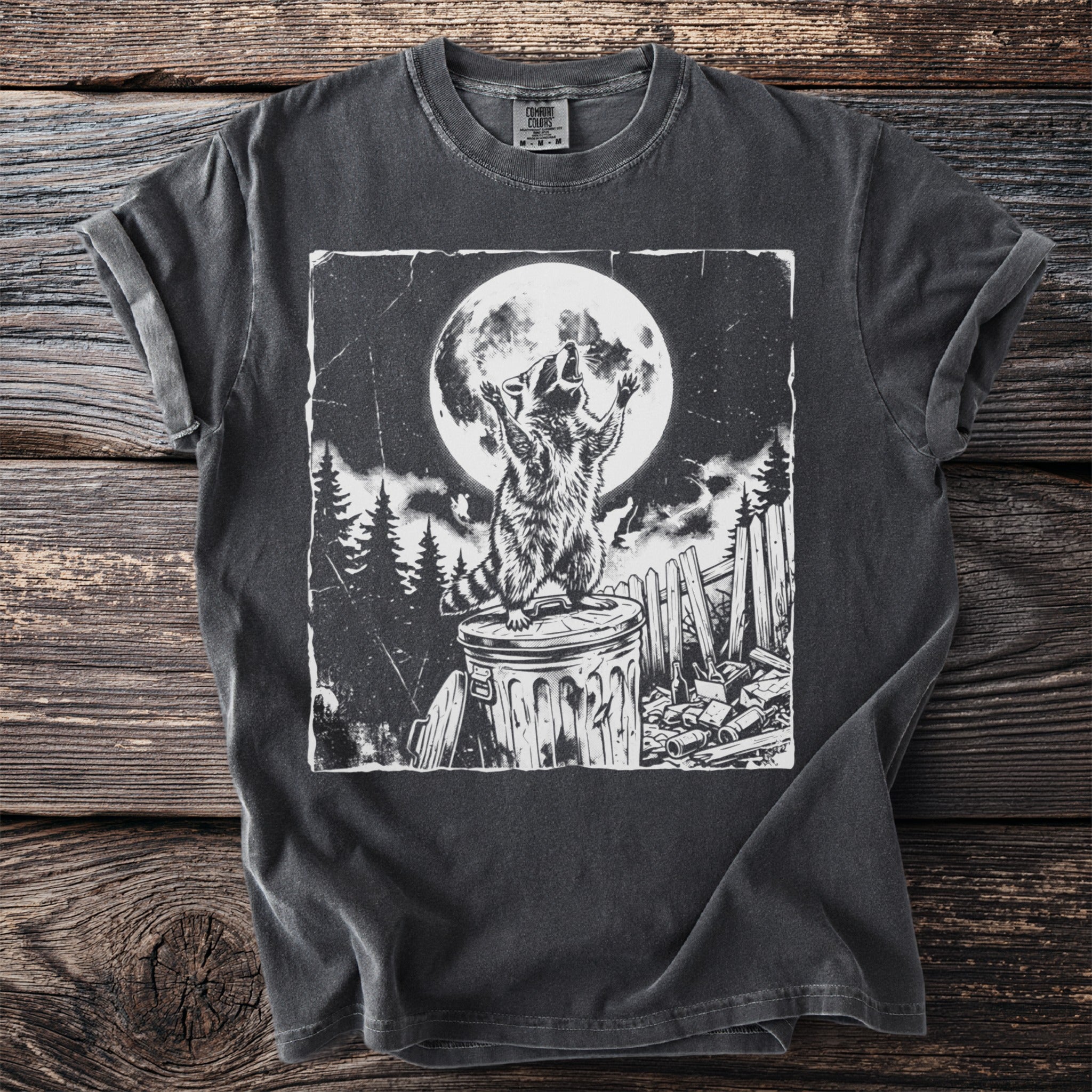 Black t-shirt with graphic of a raccoon howling at the full moon.