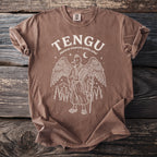 Brown t-shirt with white graphic of a Tengu with wings, holding a staff and fan.