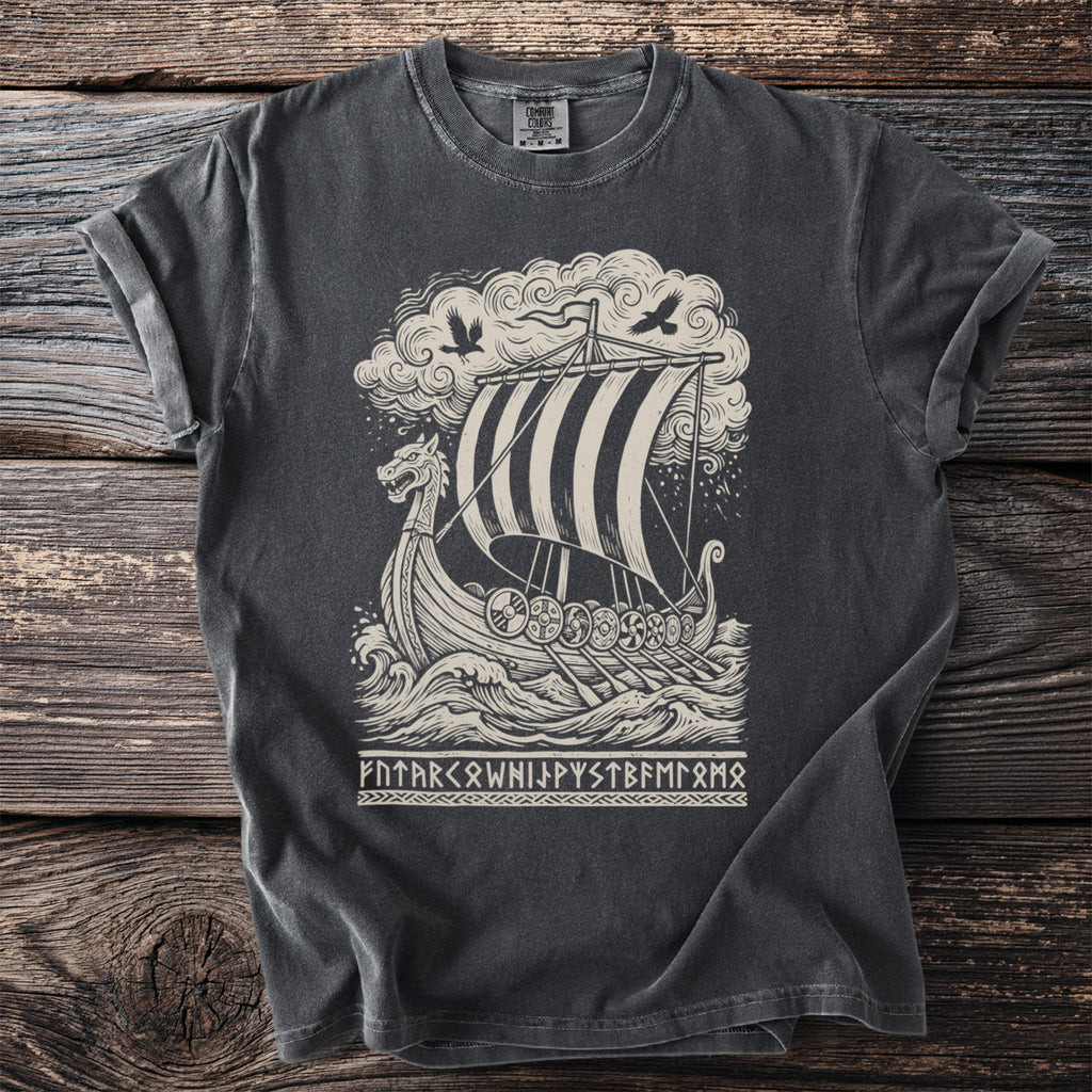 T-shirt graphic of a Viking ship sailing through rough seas with birds and runes.