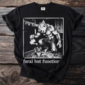 Werewolf watering a plant with text "feral but function" on a black t-shirt.