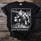 Werewolf watering a plant with text "feral but function" on a black t-shirt.