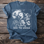 Blue t-shirt with graphic of moth, opossum, rat, raccoon, spider, frog, snail, and snake.