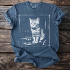 Graphic tee with a white ink sketch of a cat sitting next to a glass of ice.