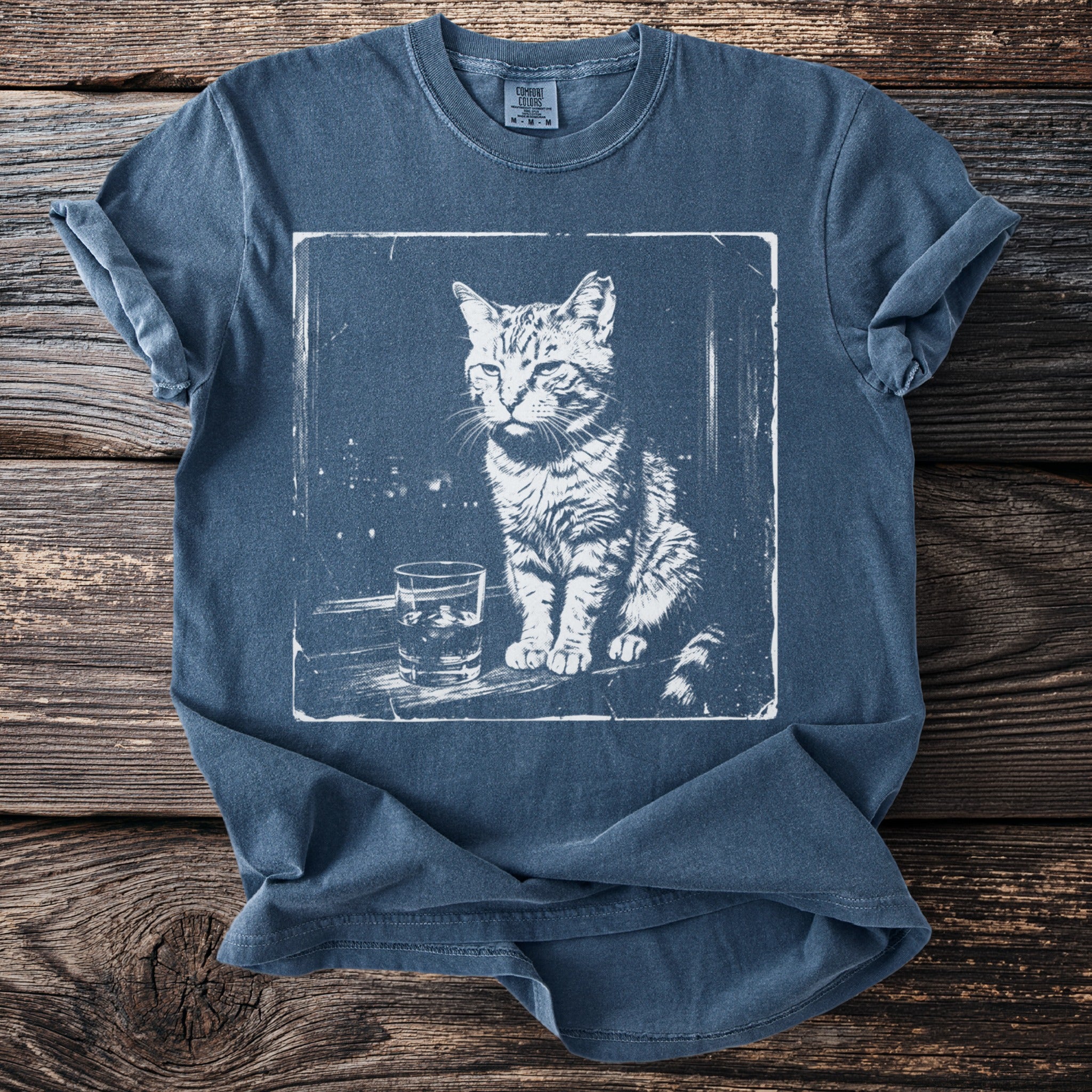 Graphic tee with a white ink sketch of a cat sitting next to a glass of ice.