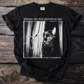 Black t-shirt with "please do not perceive me" and a peeking black cat graphic.