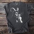 Charcoal gray t-shirt with a white graphic of Krampus blowing dandelion seeds, wearing a bell.