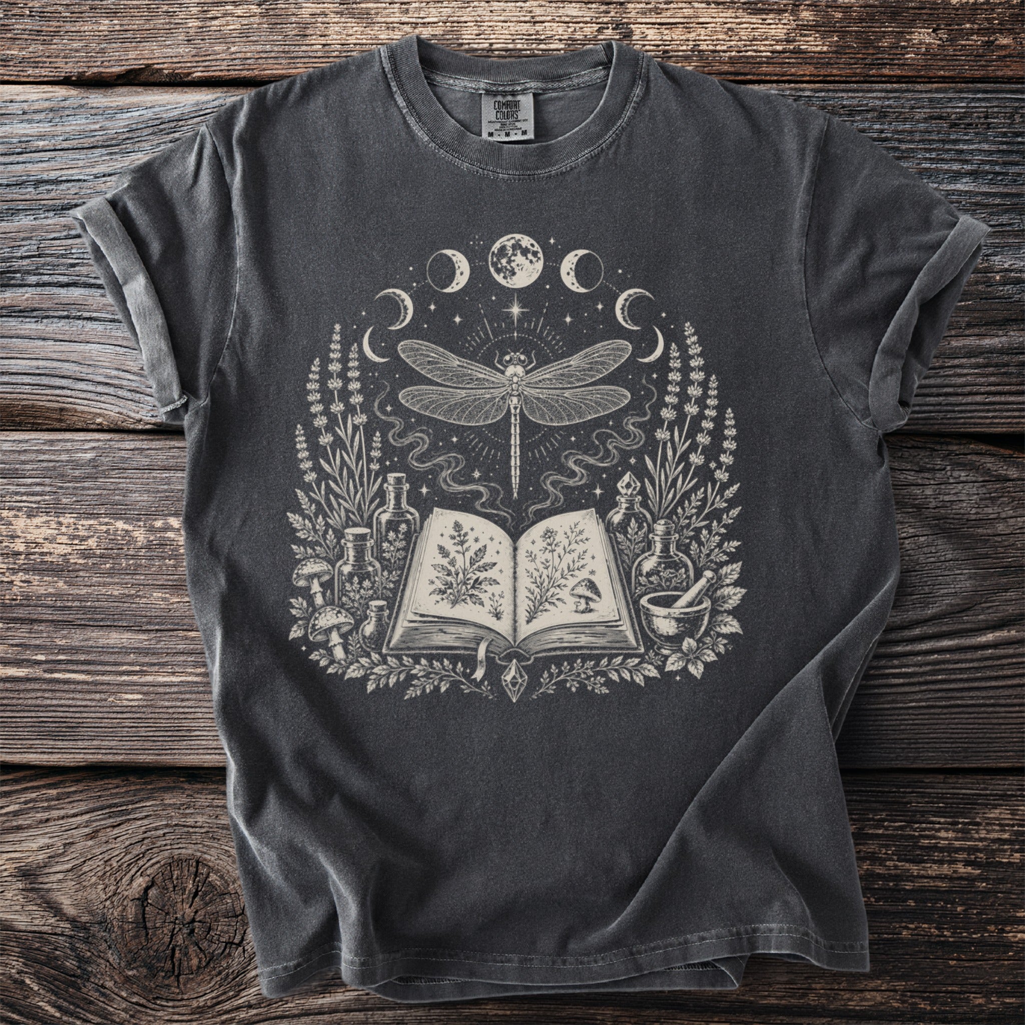Dark gray t-shirt with a circular occult graphic featuring a dragonfly and open book.