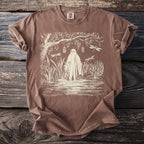 Brown t-shirt with ghost, dragonflies, and jars hanging from a tree.