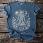 Blue t-shirt with a sun, moon, stars, and a forest spirit design.