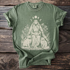 Green t-shirt with a woman, moon phases, flowers, and two cats in a line drawing.