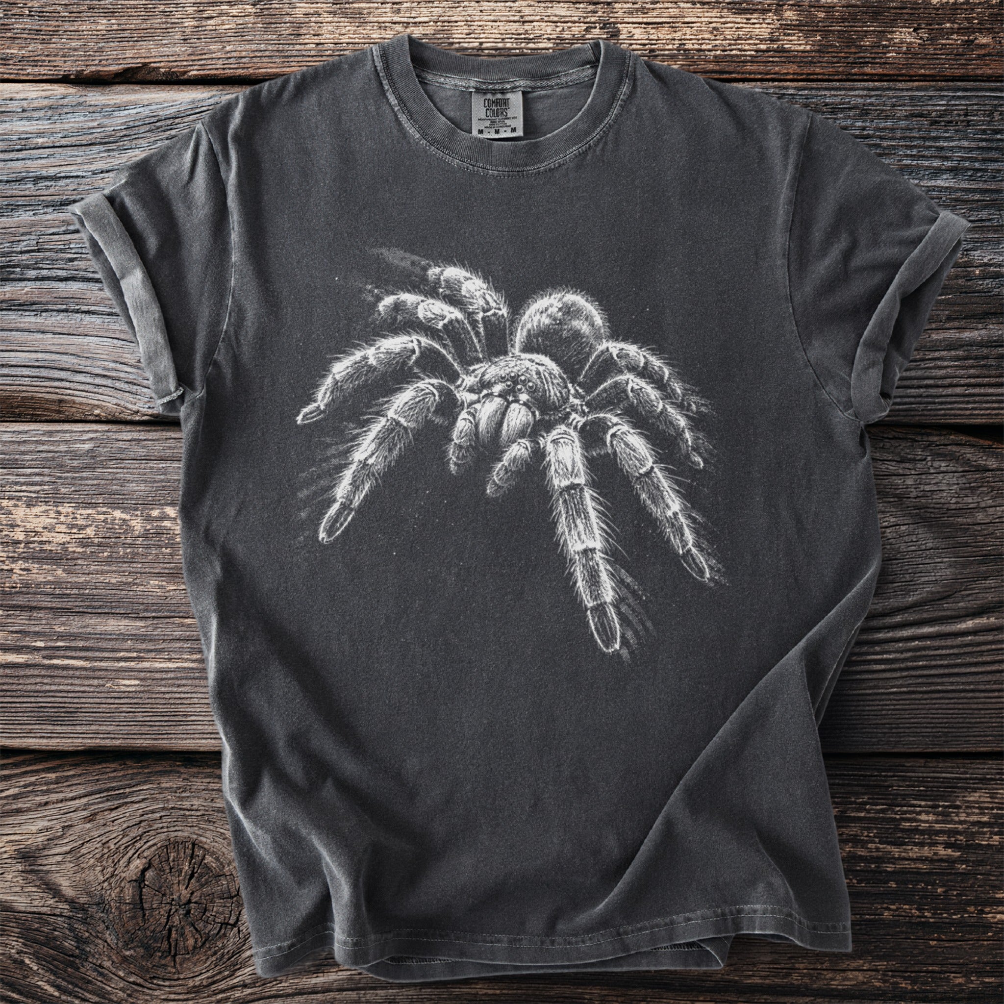 Dark grey t-shirt with a white tarantula graphic and Comfort Colors tag.