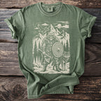 Green t-shirt with a Viking bear, wolf, and mountain graphic.