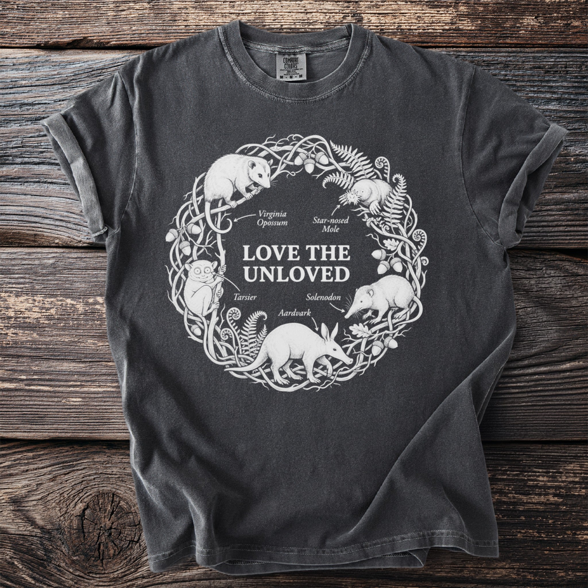 T-shirt with a white circular design of "Love the Unloved" animals and text.