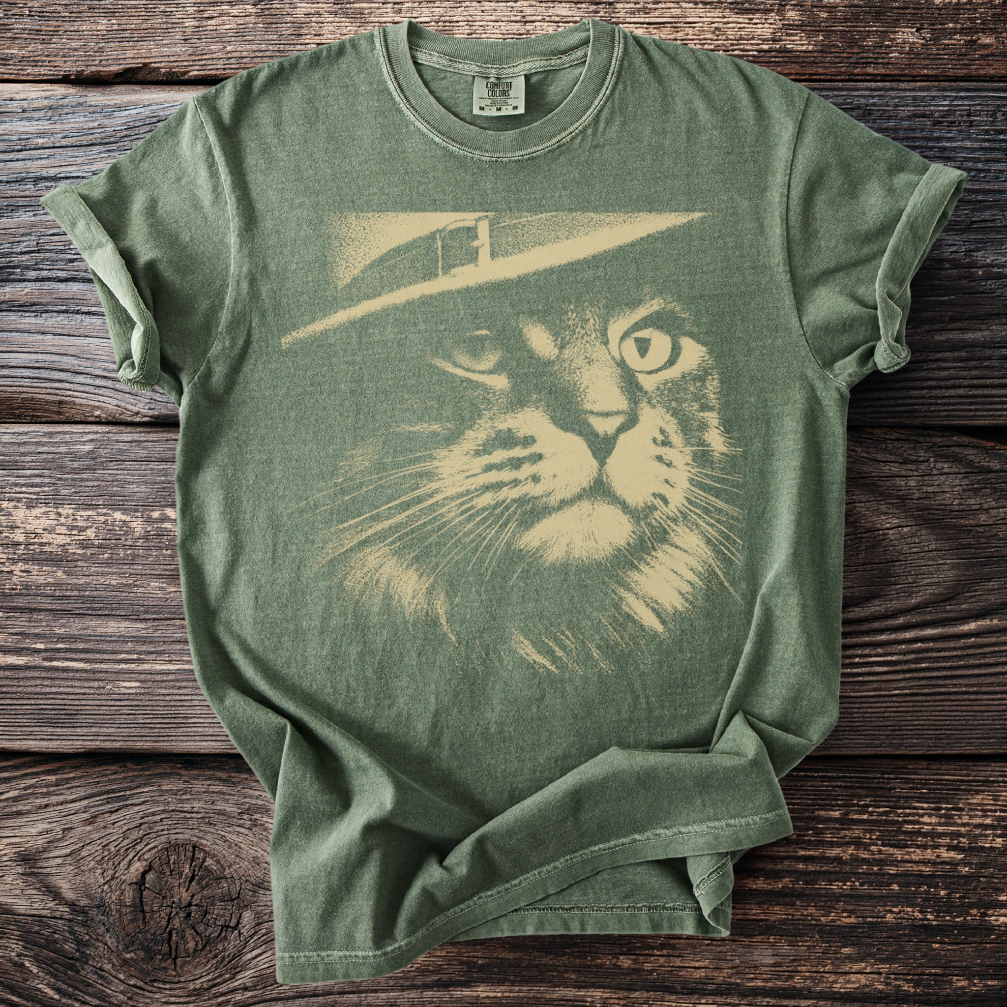 Green t-shirt with a distressed print of a cat wearing a hat.