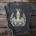 Dark gray t-shirt with a burning wicker figure encircled by participants in goat masks, with a crescent and star above.