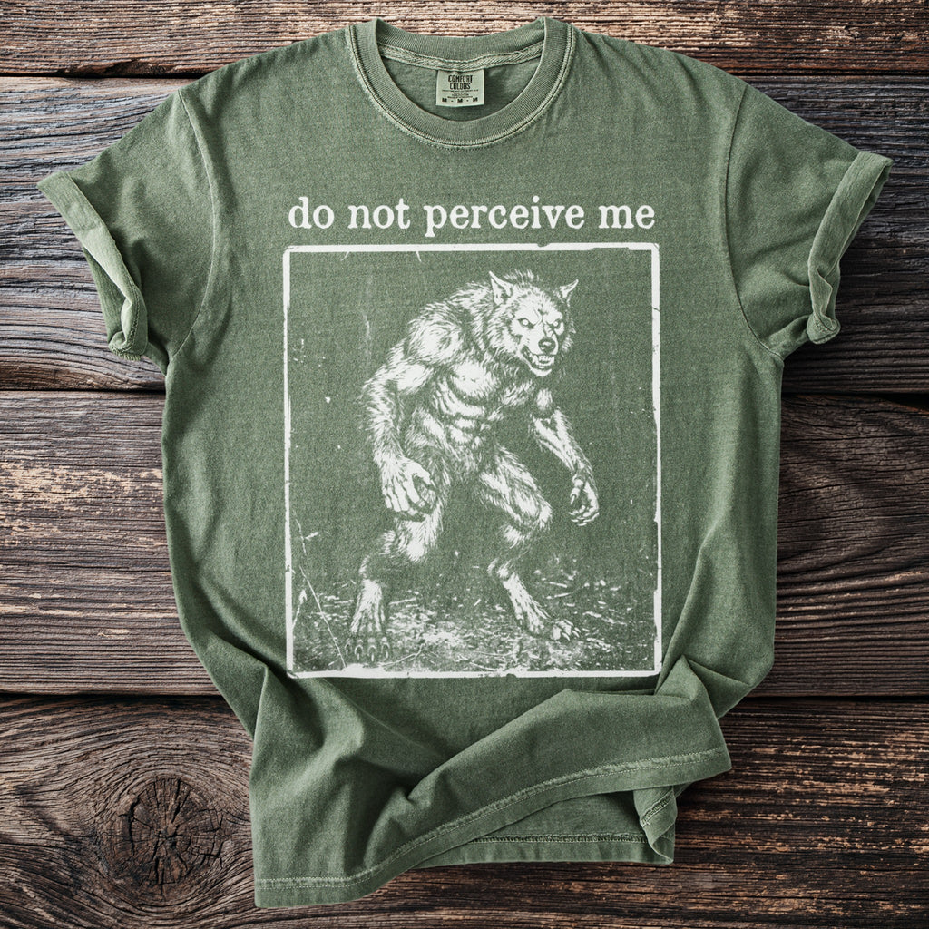 Green t-shirt with "do not perceive me" and a werewolf graphic.