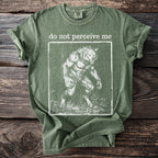 Green t-shirt with "do not perceive me" and a werewolf graphic.