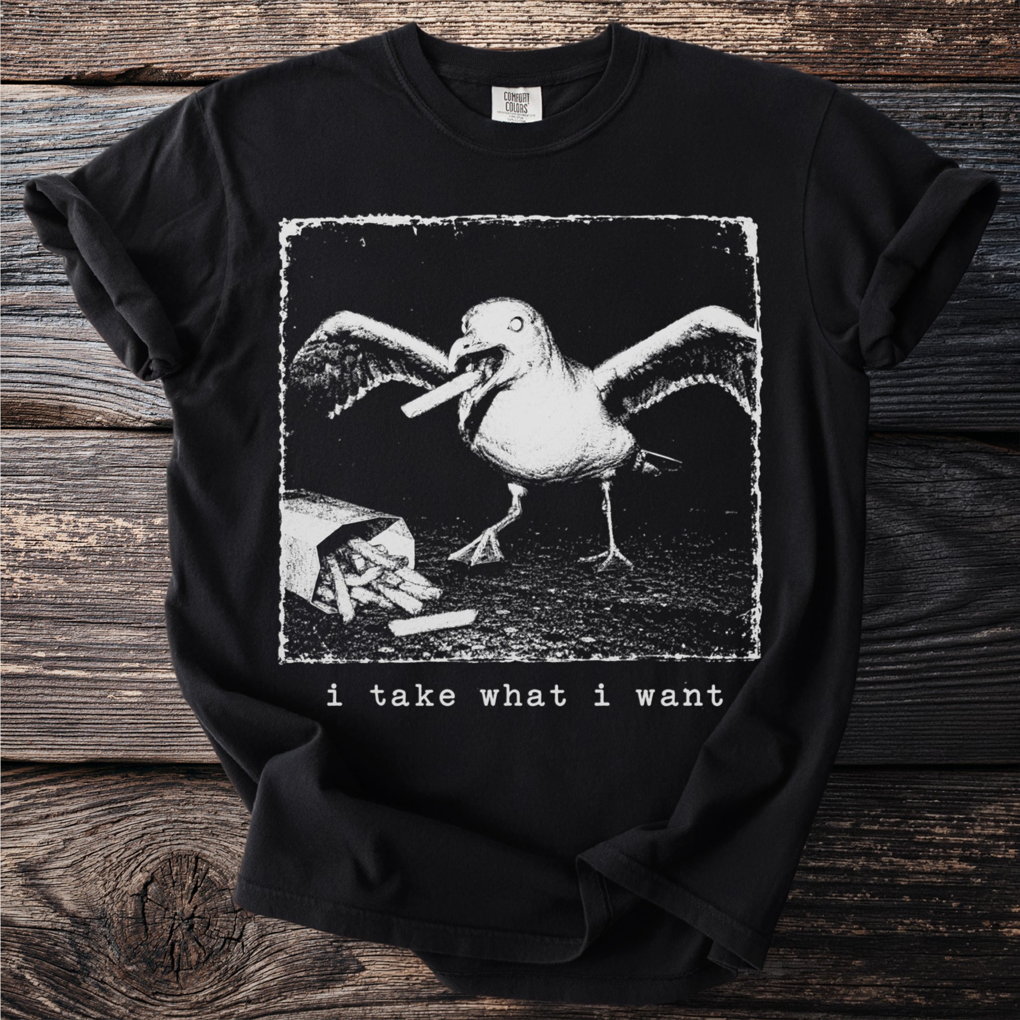 Black t-shirt with a graphic of a seagull eating fries and text "i take what i want".