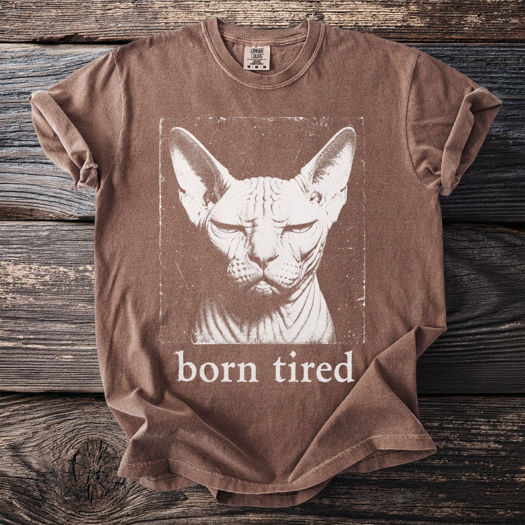 Brown t-shirt with a distressed print of a Sphynx cat and text "born tired".