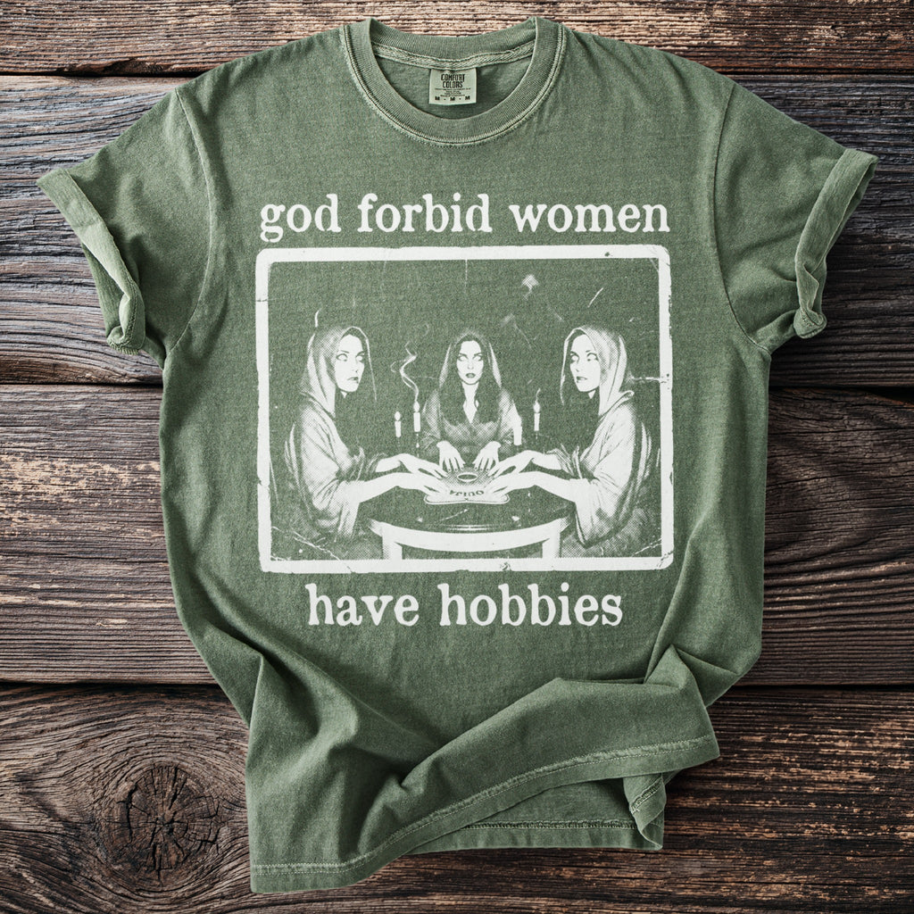 Green t-shirt with "god forbid women have hobbies" and image of women around a table.