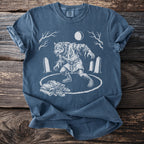 T-shirt with werewolf transformation illustration in circle, moon, trees, and gravestones.